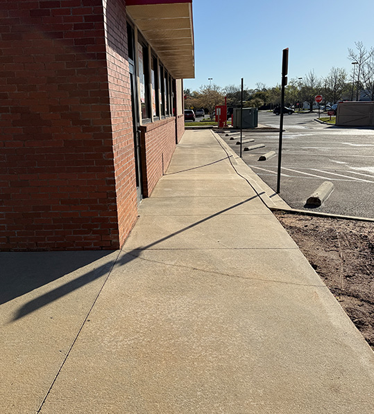 Parking lot cleaning Gulf Breeze commercial sidewalk and entryway after pressure washing